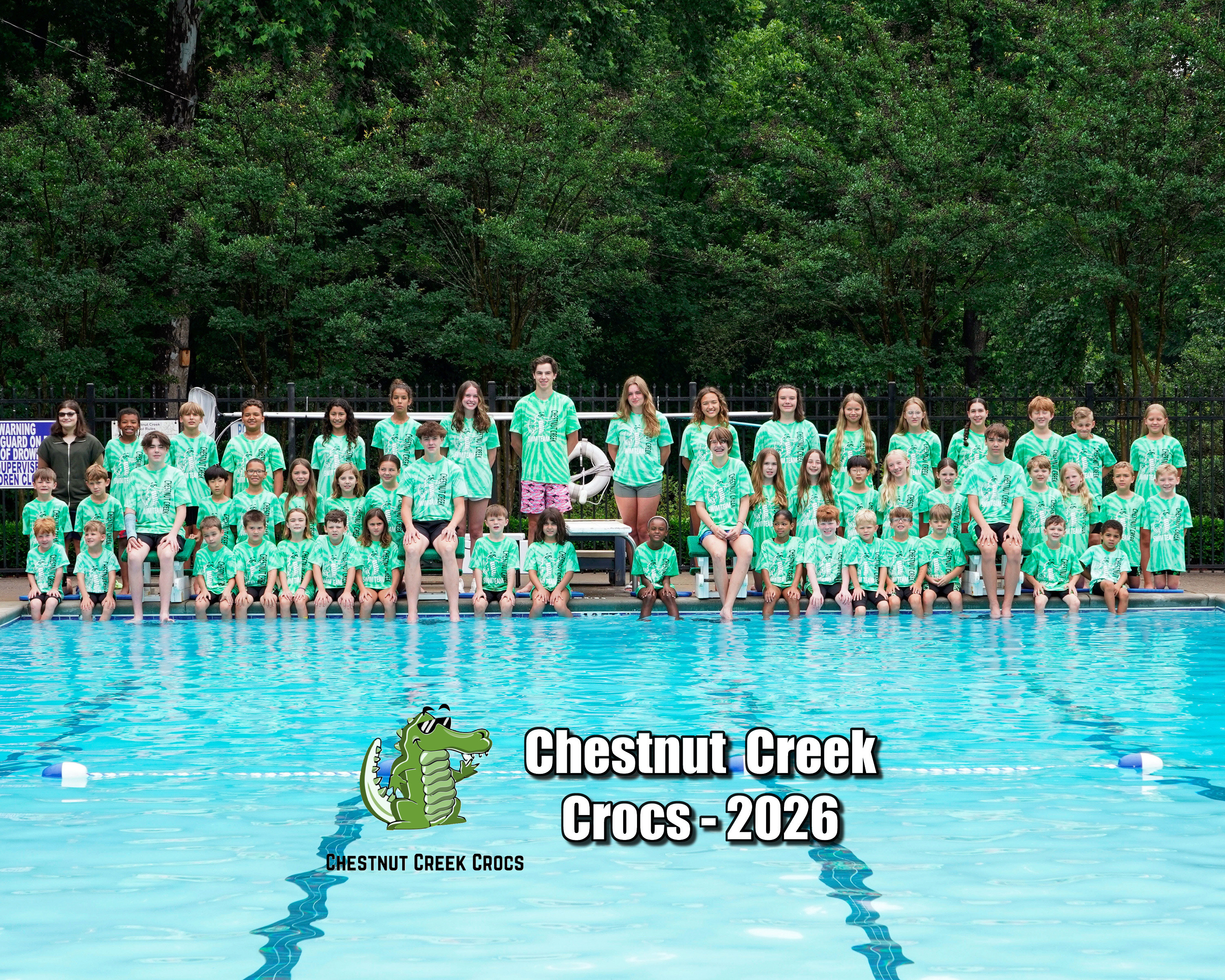 Team picture of the 2026 Crocs summer swim team by the diving board of the neighborhood pool